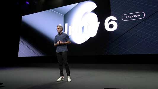 Speaker on stage at Unity's Unite 2024 conference in front of screen displaying Unity 6 text
