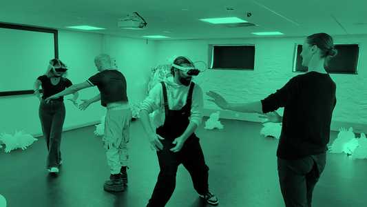 Participants with VR headsets in mixed reality experience